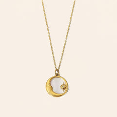 Sun and Moon shell necklace with gold-tone celestial pendant and natural shell inlay