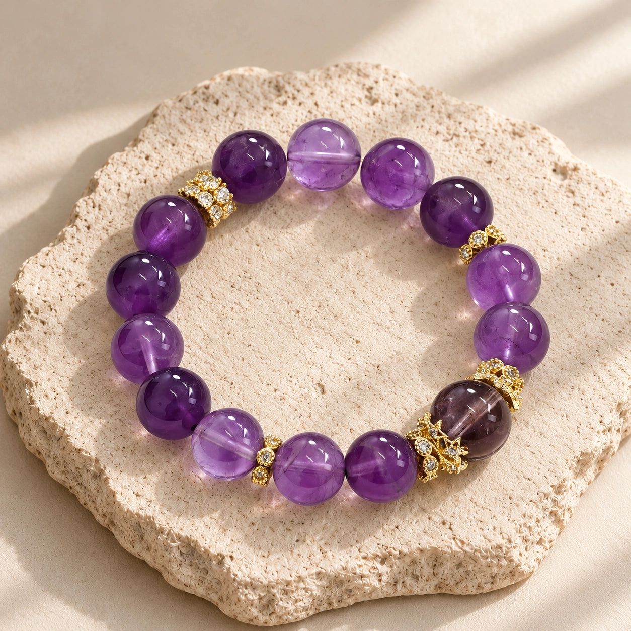 Overhead detail of 12 mm Uruguayan amethyst beads with a central amethyst accent and gold-tone embellishments