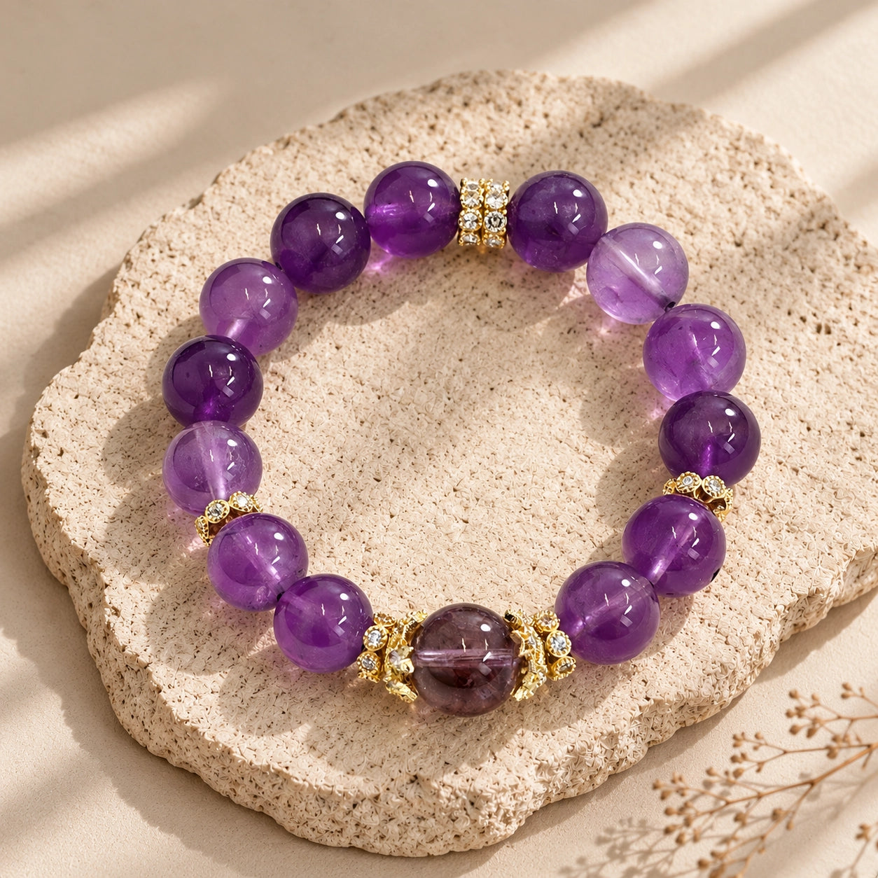 Flat lay of purple Uruguayan amethyst stretch bracelet with polished round beads and gold-tone spacer accents