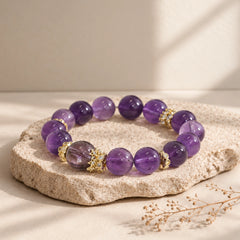 Natural Uruguayan amethyst beaded bracelet in a styled product scene, highlighting the contrasting center bead