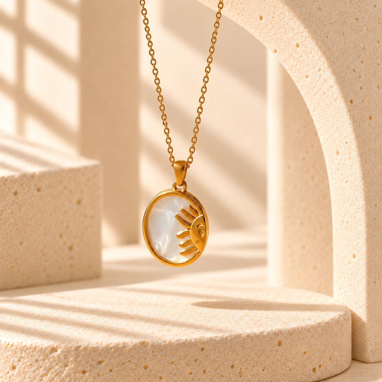 Celestial-inspired gold-tone necklace featuring a natural shell inlay pendant and delicate chain in a minimalist product image