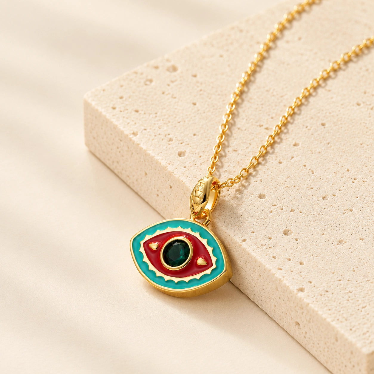 Aqua and red enamel evil eye pendant necklace with green zircon center stone for protection.