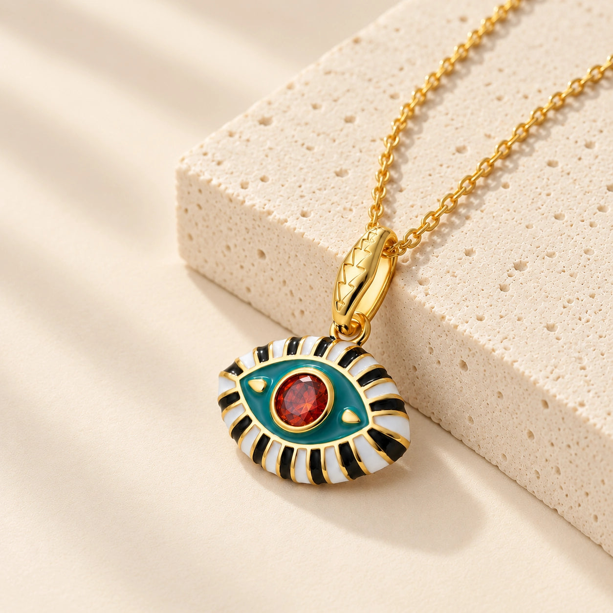 18K gold plated evil eye pendant necklace with aqua enamel and red zircon center stone.