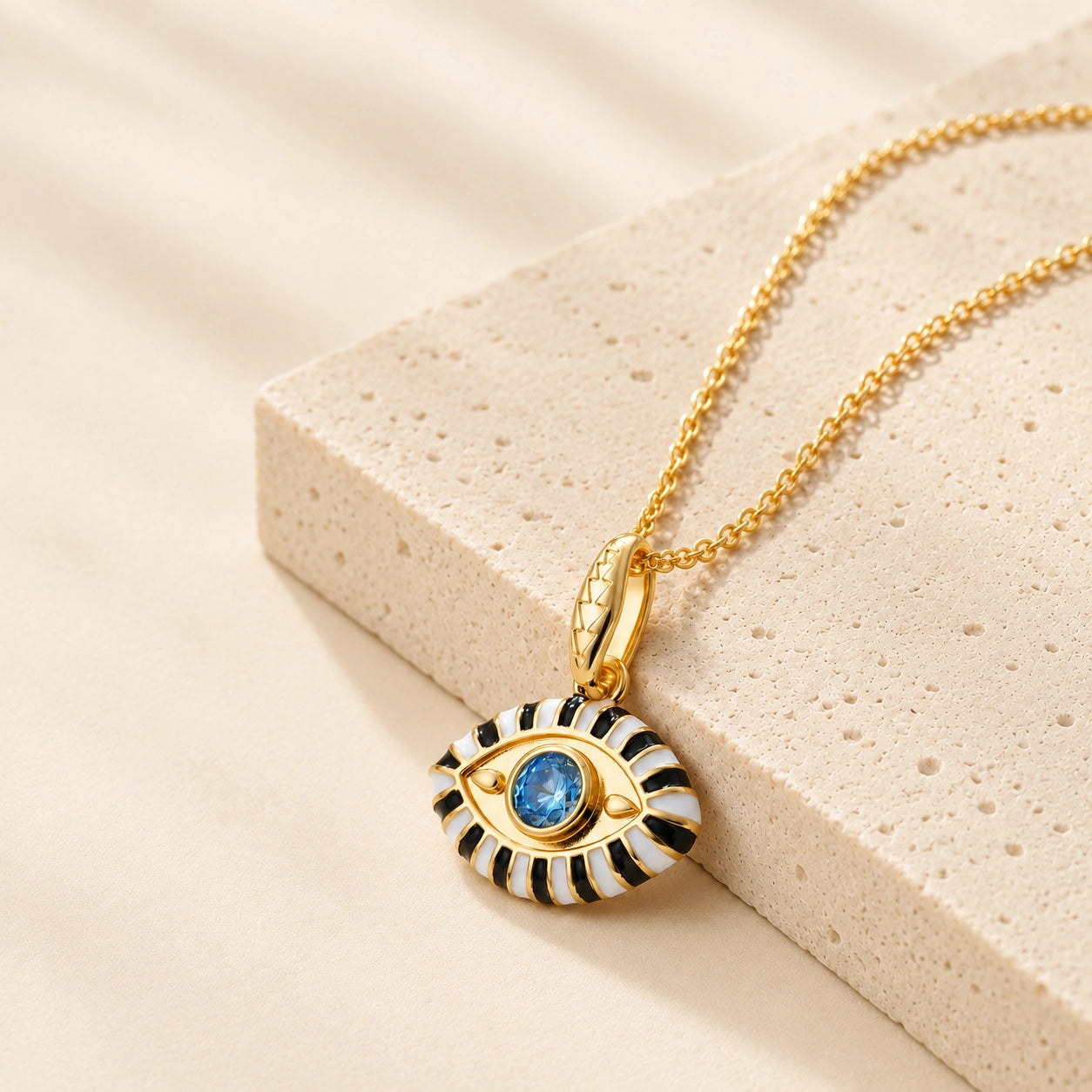 18K gold plated evil eye pendant necklace with white enamel and blue zircon center stone.