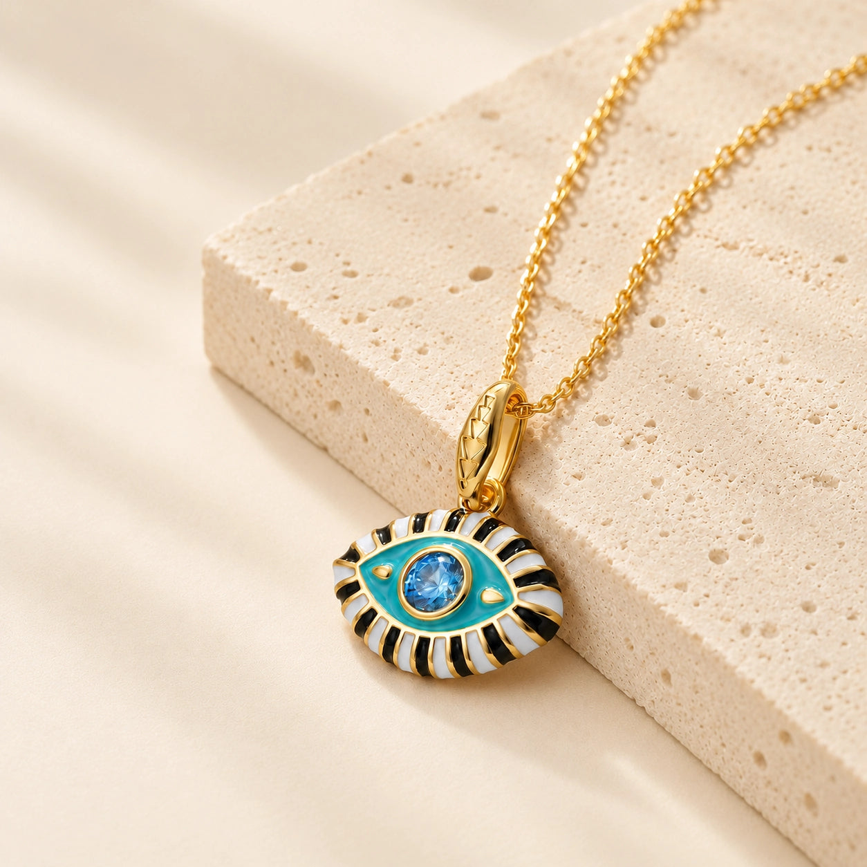 Aqua enamel evil eye pendant necklace with blue zircon center stone and 18K gold plated chain.