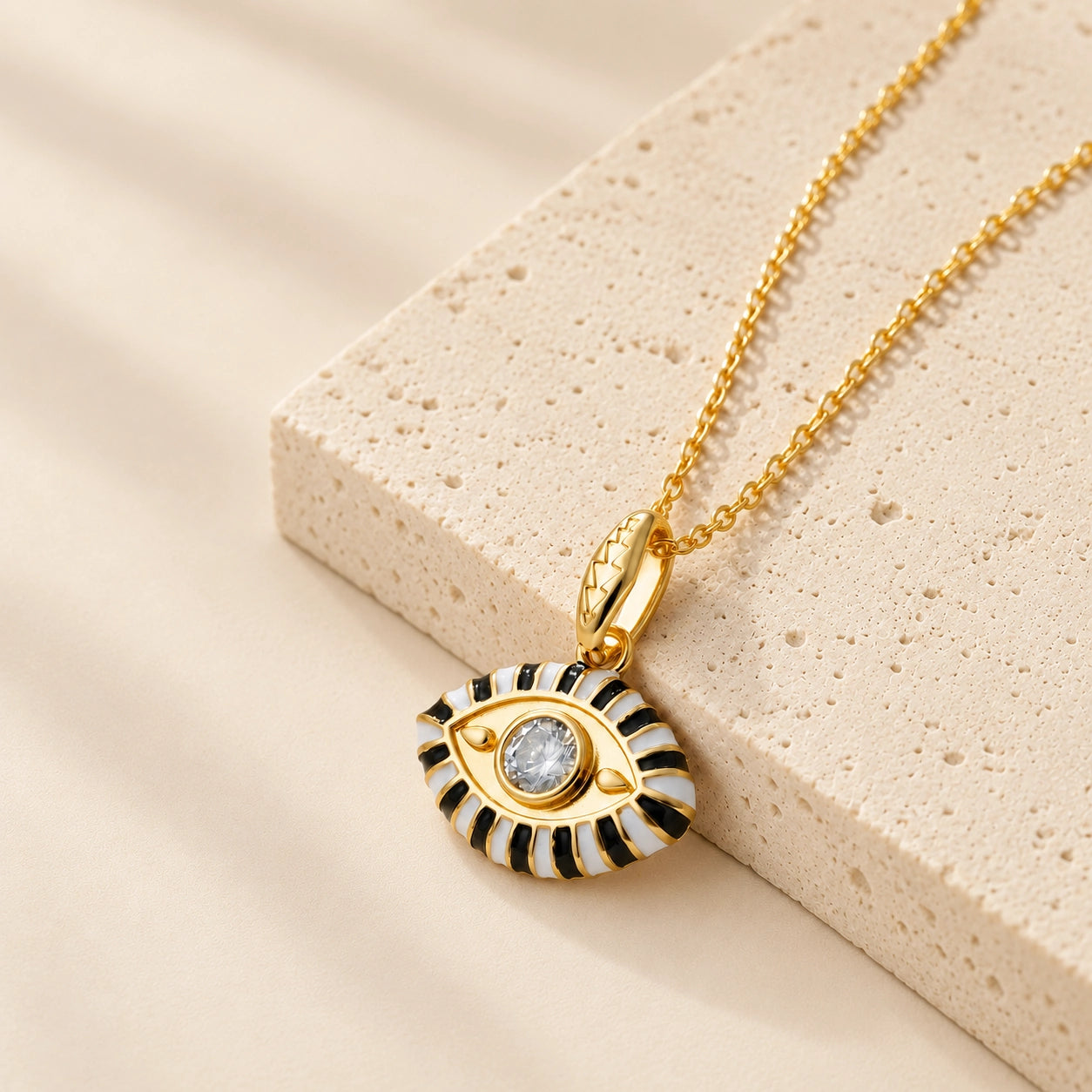 White enamel evil eye pendant necklace with clear zircon center stone and gold plated chain.