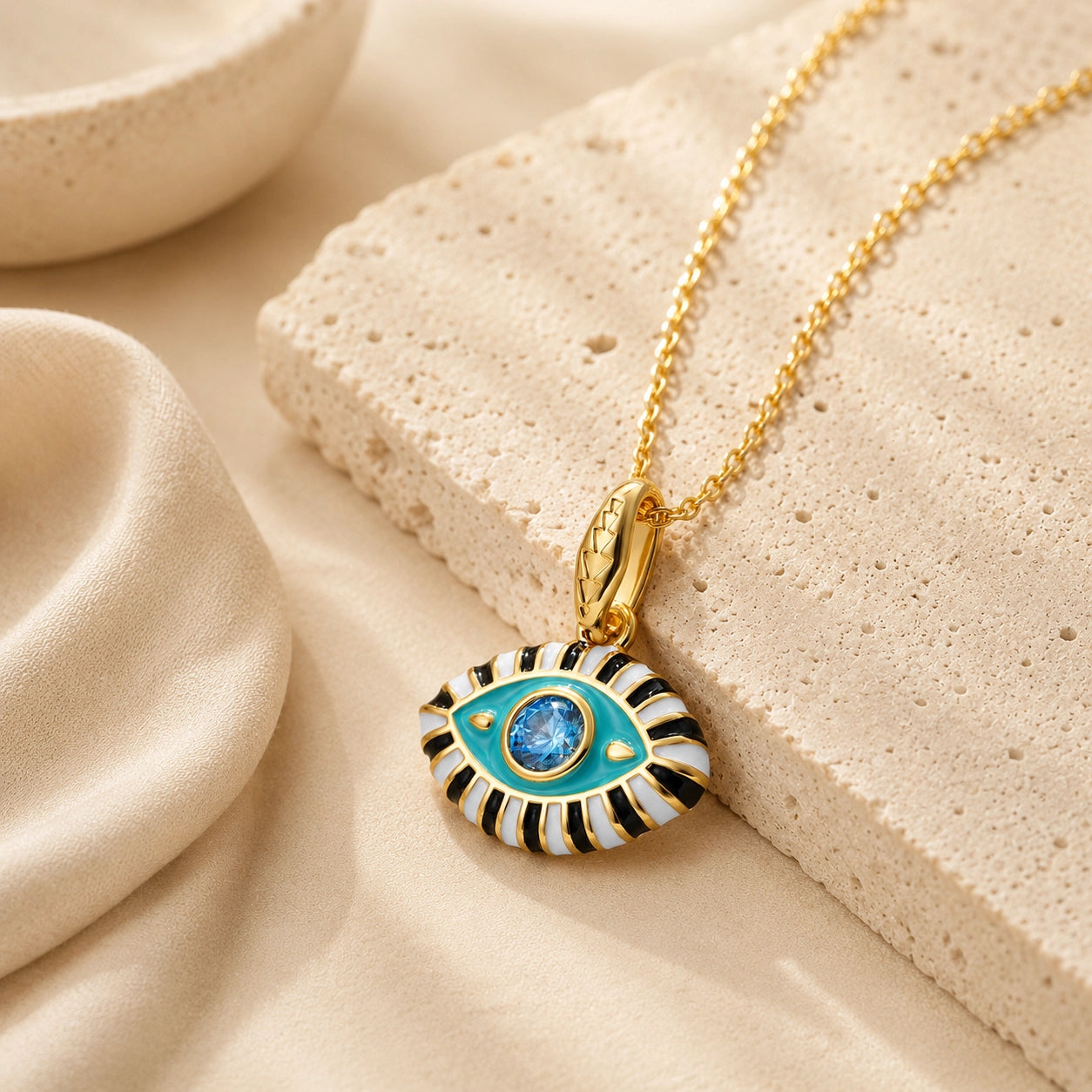 Aqua enamel evil eye pendant necklace with blue zircon center stone and 18K gold plated chain.
