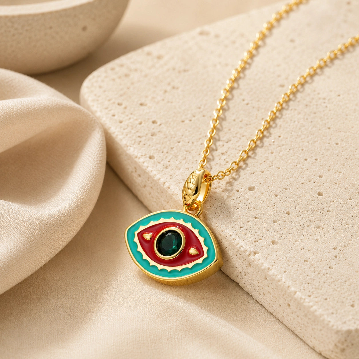 Aqua and red enamel evil eye pendant necklace with green zircon center stone for protection.