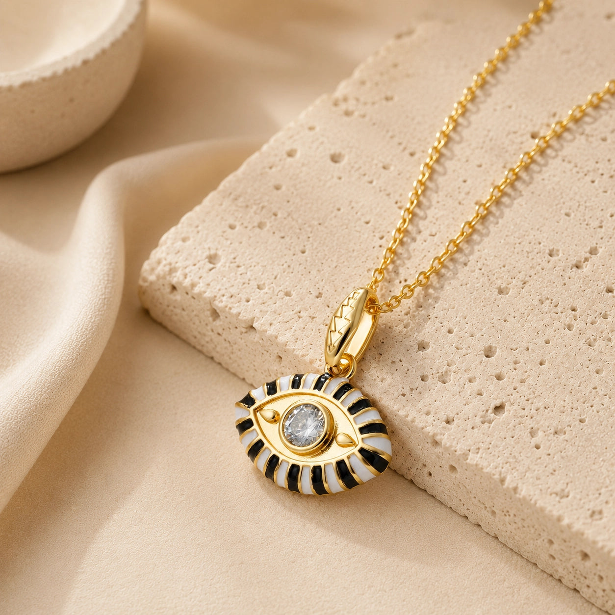 White enamel evil eye pendant necklace with clear zircon center stone and gold plated chain.