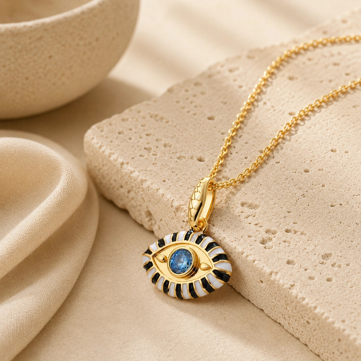 18K gold plated evil eye pendant necklace with white enamel and blue zircon center stone.