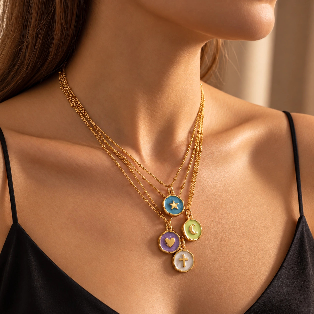 Gold-tone electroplated copper charm necklace with enamel details and beaded chain accents