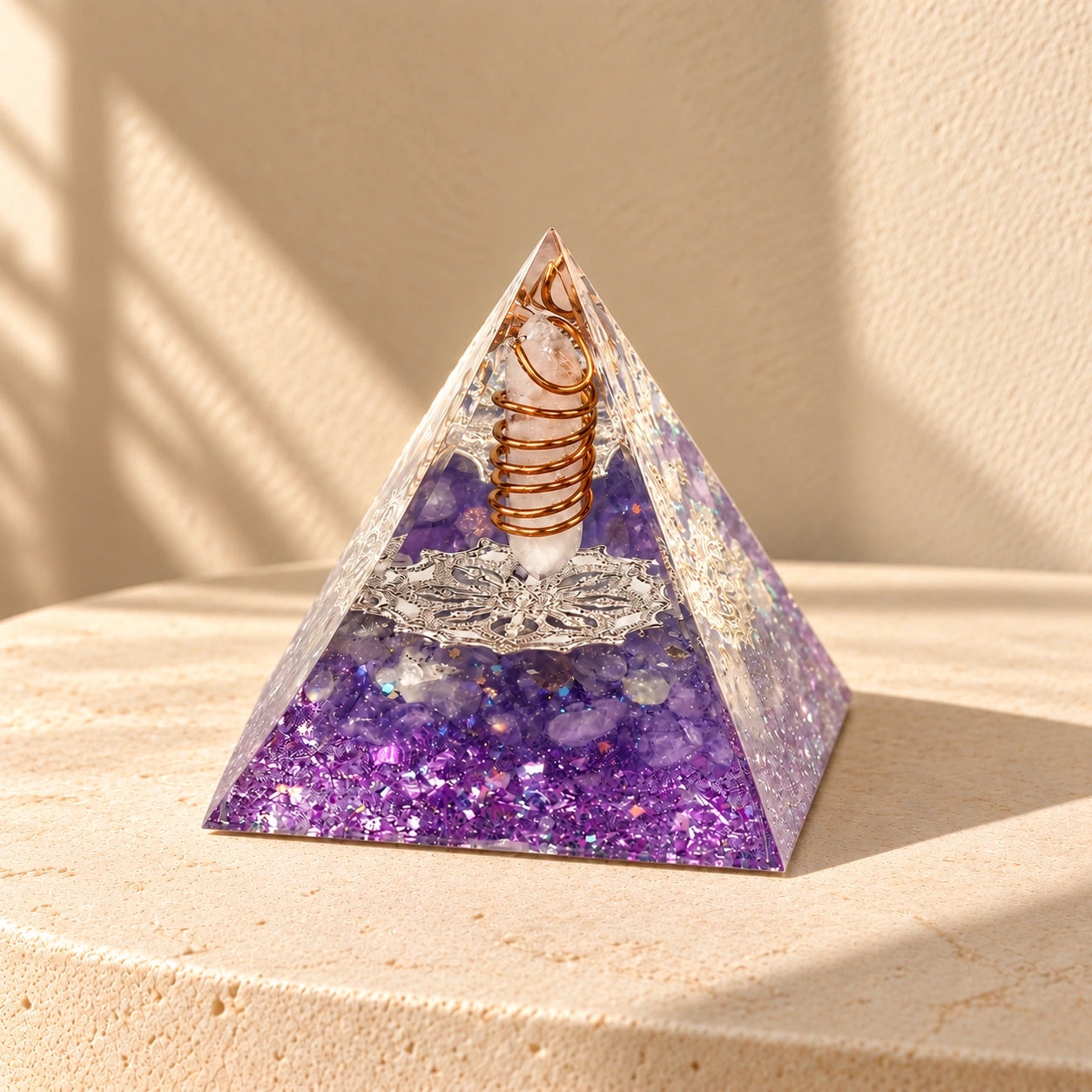 Amethyst and clear quartz orgonite pyramid for meditation and journaling spaces in soft natural sunlight