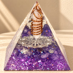 Intuition and inner guidance orgonite pyramid with amethyst and clear quartz styled in warm natural sunlight