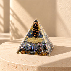 Obsidian and labradorite orgonite pyramid with dark resin, copper coil and gold foil details