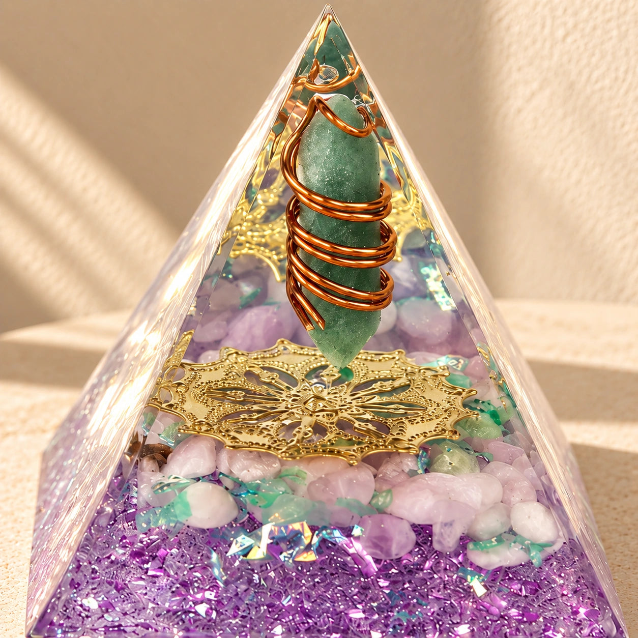 Restore Love orgonite pyramid with rose quartz and green aventurine styled in warm natural sunlight