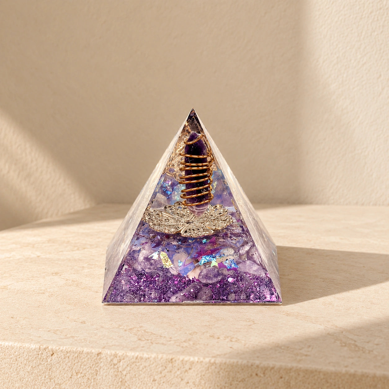 Family Harmony orgonite pyramid with amethyst, dried lilac and purple details in warm natural sunlight