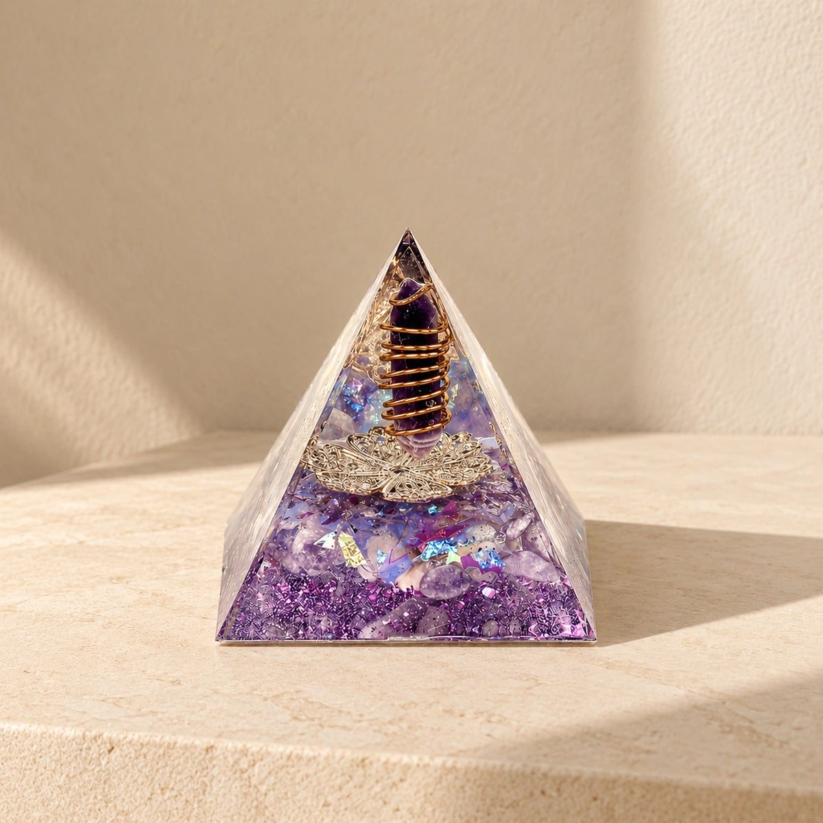 Family Harmony orgonite pyramid with amethyst, dried lilac and purple details in warm natural sunlight