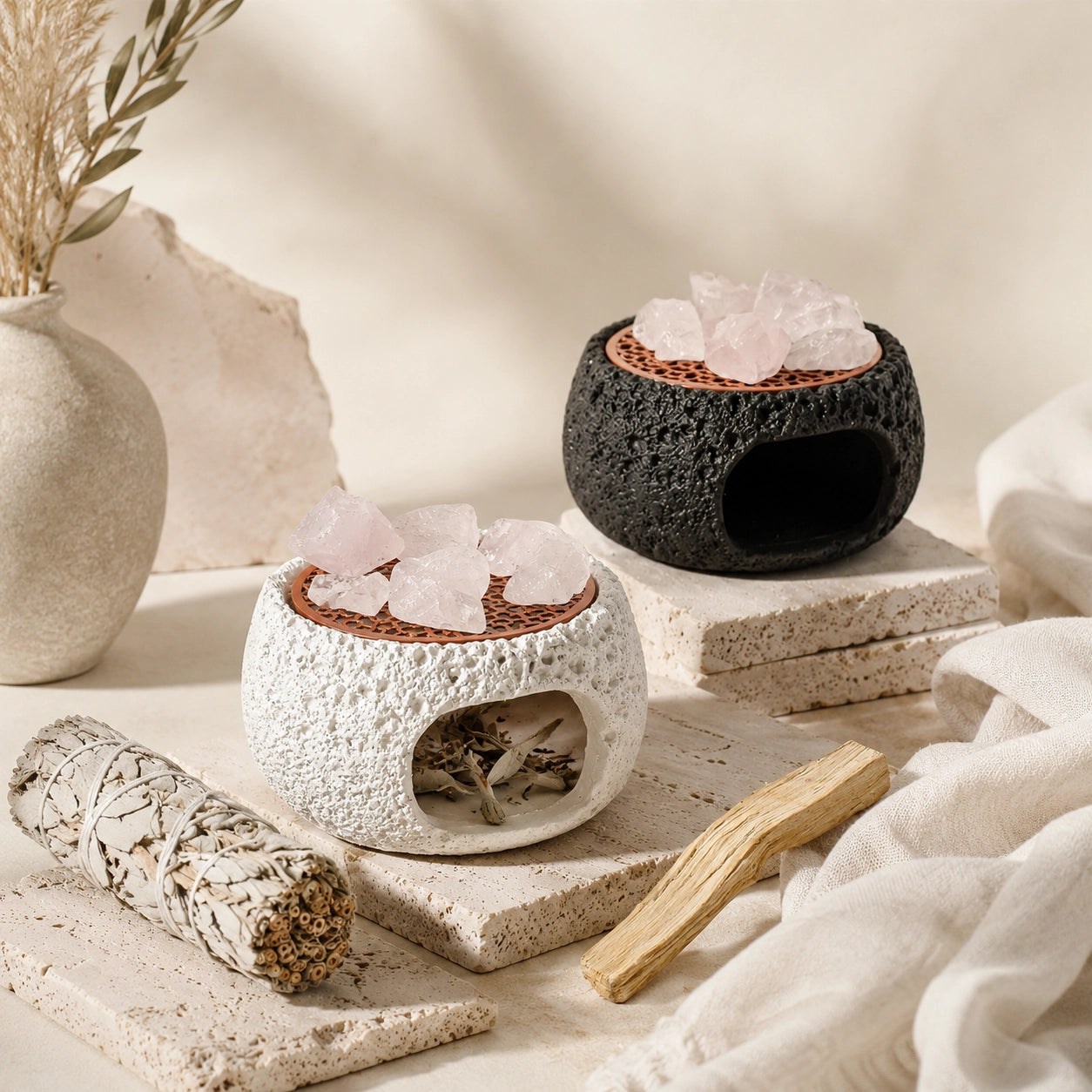 Nordic crystal cleansing burner with sage bundle, palo santo wood, clear quartz stones, and black and white ceramic smudge holders