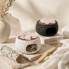 Nordic crystal cleansing burner with sage bundle, palo santo wood, clear quartz stones, and black and white ceramic smudge holders