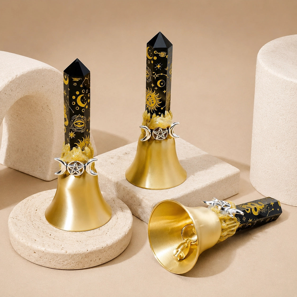 Black celestial obsidian crystal point bell with gold sun and star symbols, featuring a polished obsidian point mounted on a gold metal bell base.