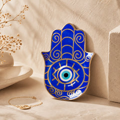 Blue Hamsa Evil Eye Ceramic Trinket Dish displayed as spiritual protection decor on a neutral shelf.