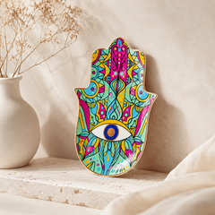 Colorful Hamsa Evil Eye Ceramic Trinket Dish with glossy finish displayed as spiritual protection decor on a neutral shelf.