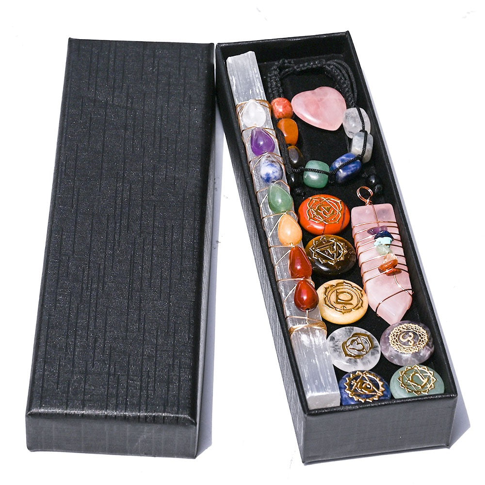 Set of crystal healing stones in a black box on a white background