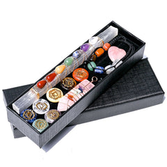 Set of crystals and tools in a black box on a white background