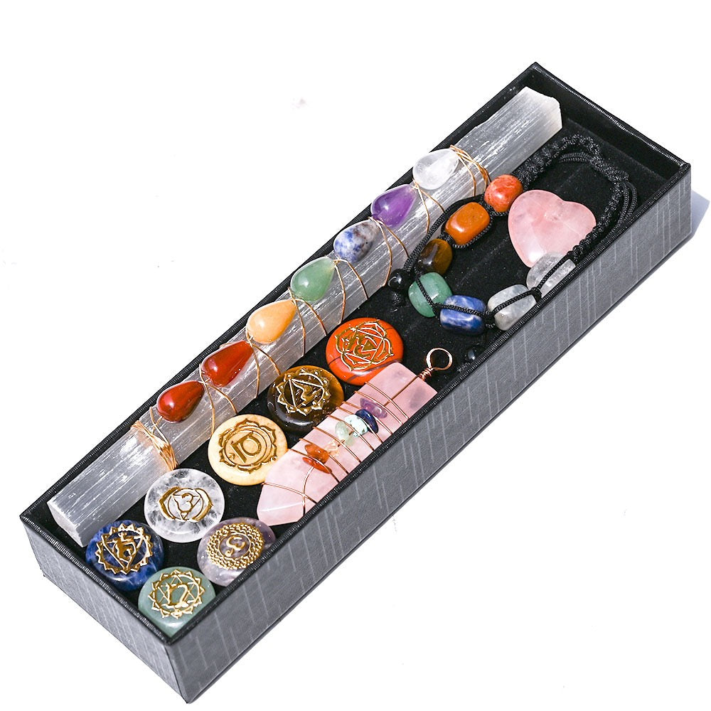 Set of crystals and tools in a box on a white background