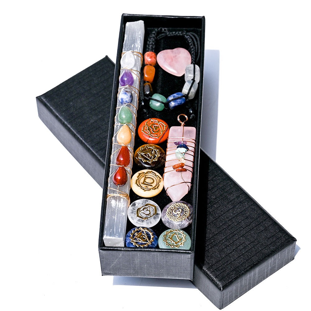 Set of crystals and chakra stones in a black box on a white background