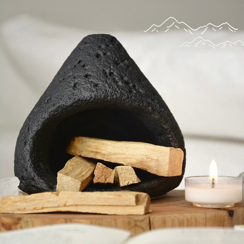 Black ceramic smudge bowl designed for incense and ritual smoke cleansing.