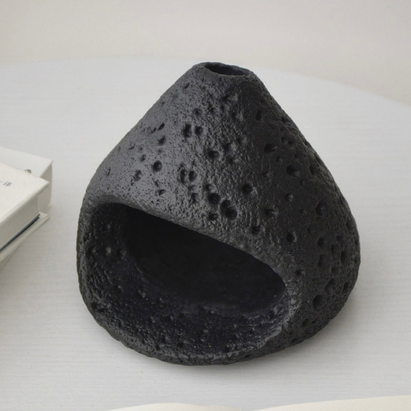 Black ceramic smudge bowl designed for incense and ritual smoke cleansing.