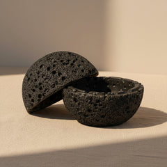 Black volcanic stone with a textured surface on a white background