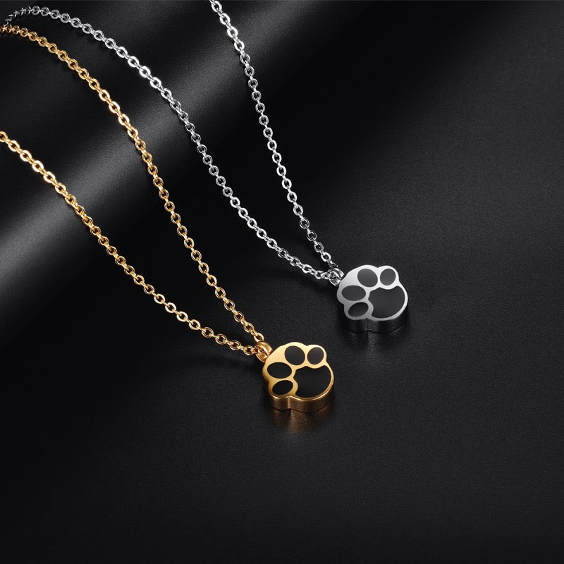 gold and silver paw print cremation necklace for pet ashes