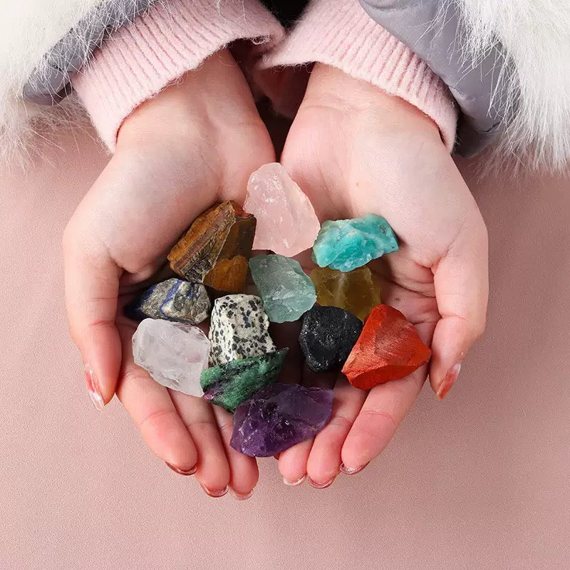 Colorful raw chakra stones aligned on an arm for meditation and healing rituals