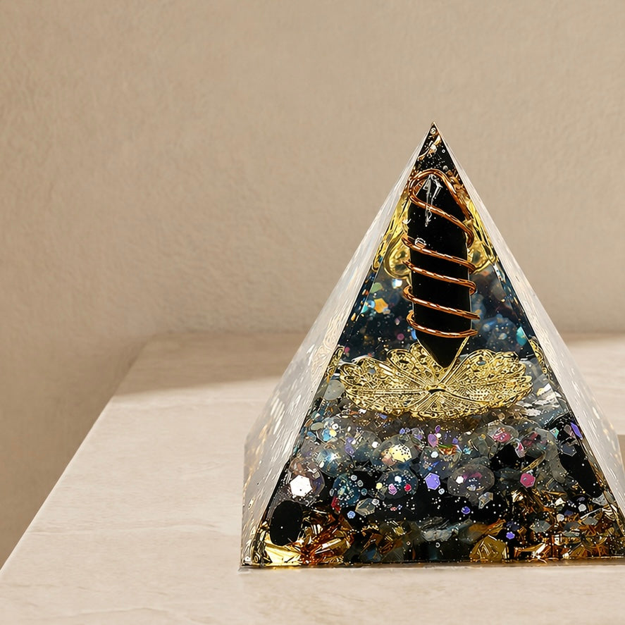 Close-up of a protection and energy shield orgonite pyramid with obsidian point, labradorite chips and copper coil details