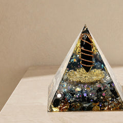 Close-up of a protection and energy shield orgonite pyramid with obsidian point, labradorite chips and copper coil details
