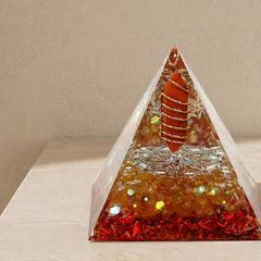 Close-up of a vitality and courage orgonite pyramid with red jasper point, citrine chips and copper coil details
