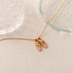 pink ballet shoes necklace in gold, symbolic jewelry for softness and inner light