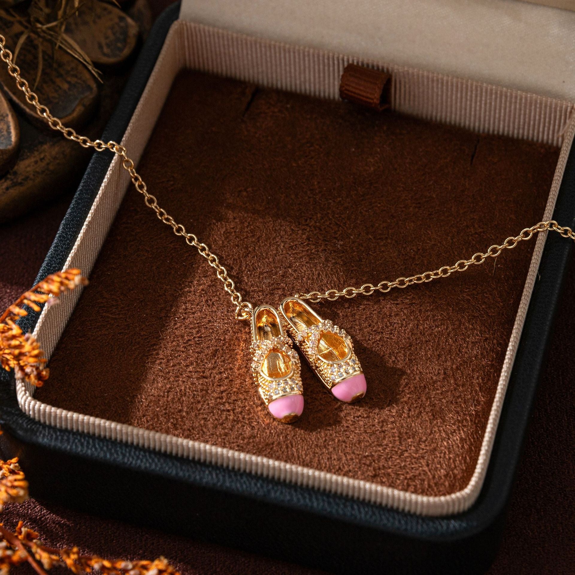 pink ballet shoes necklace in gold, symbolic jewelry for softness and inner light