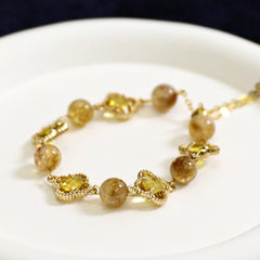 natural citrine clover bracelet with golden crystal clover charms symbolizing abundance and wealth