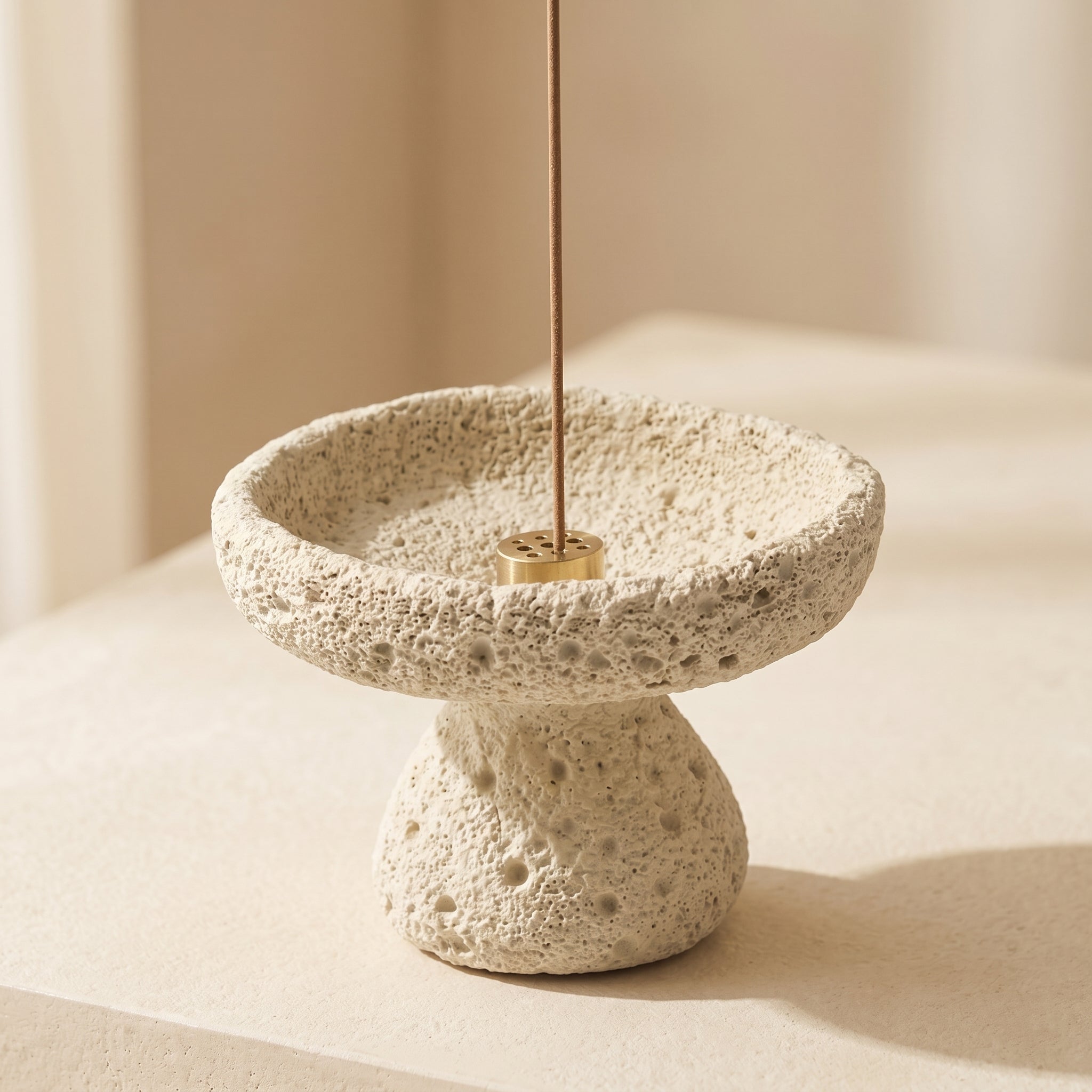nordic crystal cleansing bowl styled with an incense holder in textured cement finish