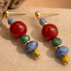 close up of red agate and sodalite earrings with colorful beads and copper ear pins