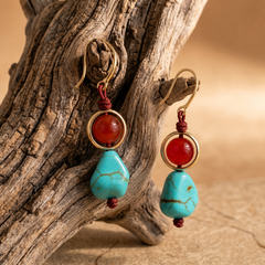 red agate turquoise drop earrings displayed on driftwood for boho spiritual jewelry