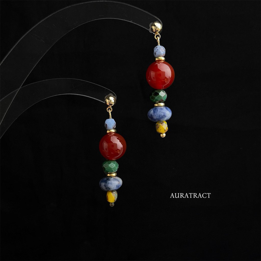 red agate and sodalite handmade drop earrings on black background with Auratract branding