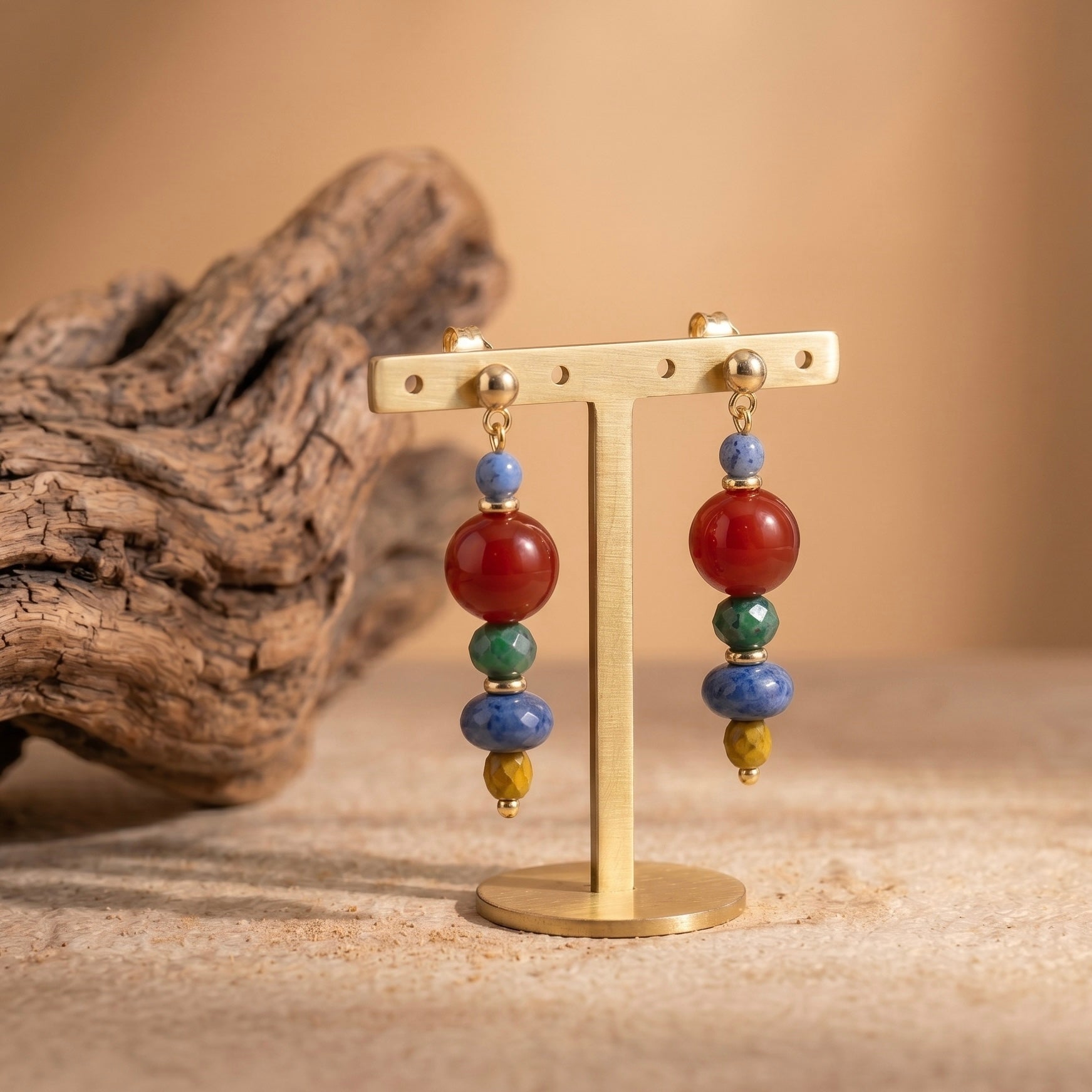 red agate and sodalite handmade earrings displayed on gold stand for courage and clarity jewelry