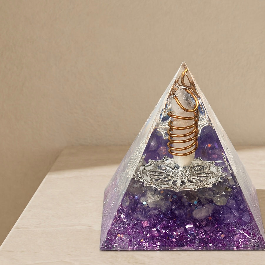 Close-up of an intuition and inner guidance orgonite pyramid with amethyst chips, clear quartz point and copper coil details