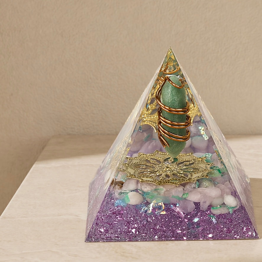 Close-up of a restore love orgonite pyramid with green aventurine point, rose quartz chips and copper coil details