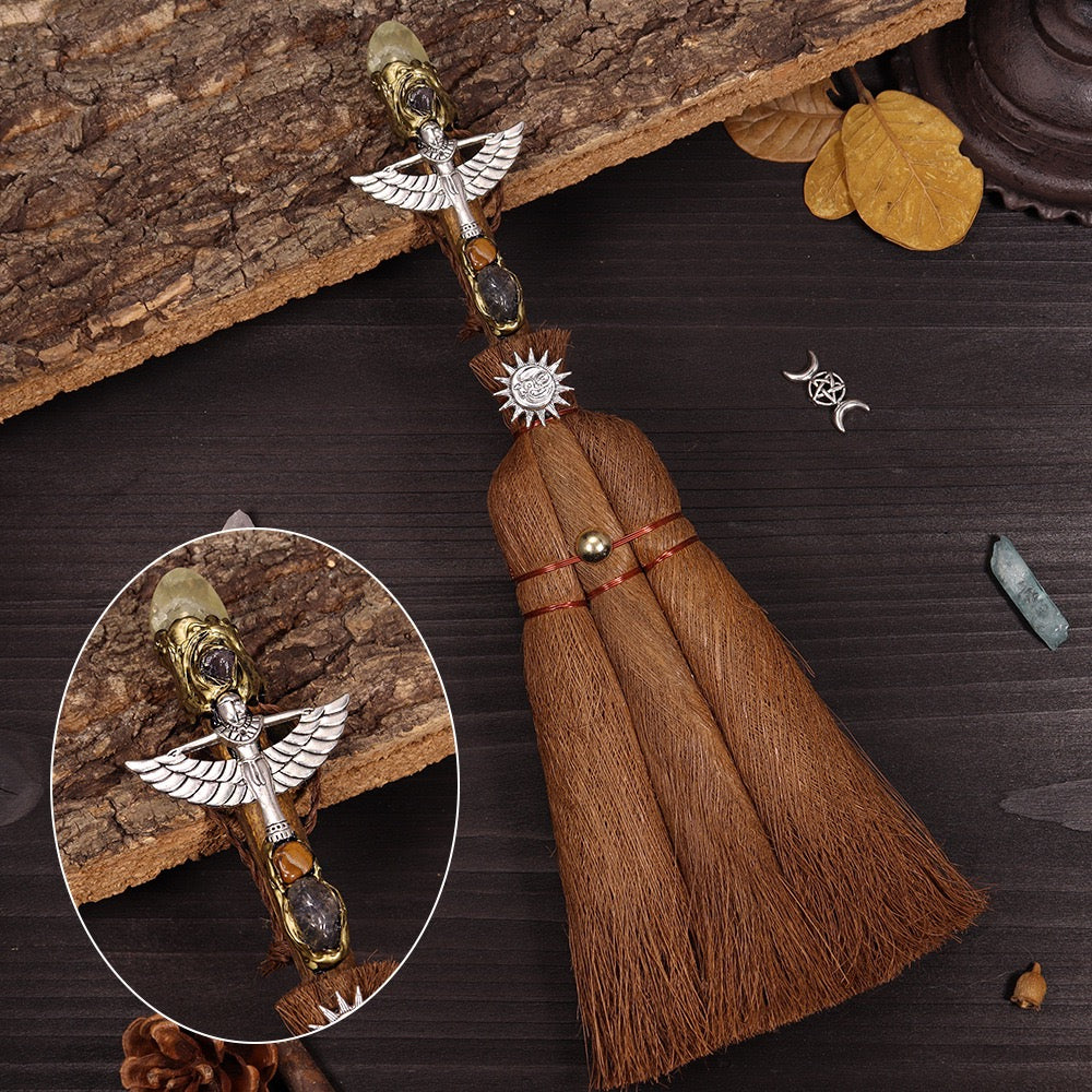 	Cleansing broom with yellow crystal and sun symbol for energy boosting rituals