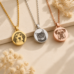 Custom pet memorial necklaces in gold, silver, and rose gold with engraved pet portraits on stainless steel keepsake pendants.